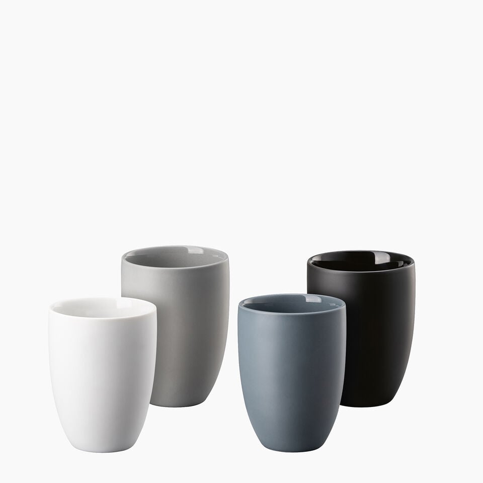 Four Rosenthal Origami small, round porcelain containers on eggshell colored linen surface