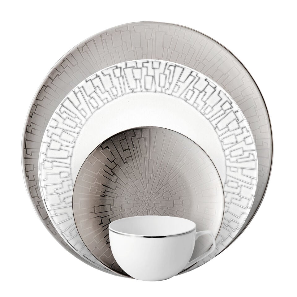 Various silver dishes stacked in front of each other