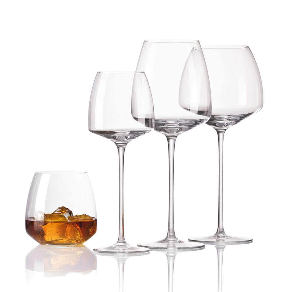 Various Rosenthal TAC 02 wine glasses on black stone background.