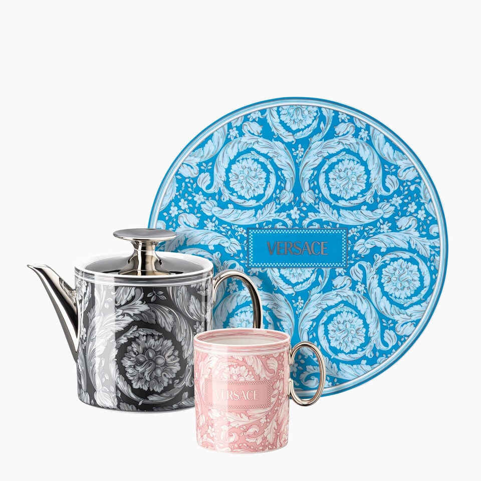 Versace meets Rosenthal Barocco plate in blue, mug in light pink and a black tea pot on white background