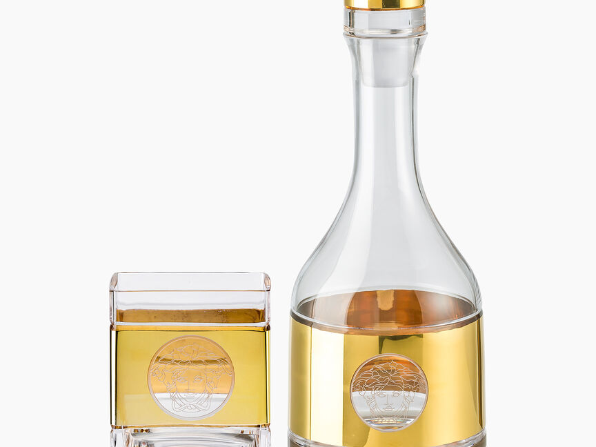 Versace Medusa Lumiere Haze Whiskey glasses on marble table
