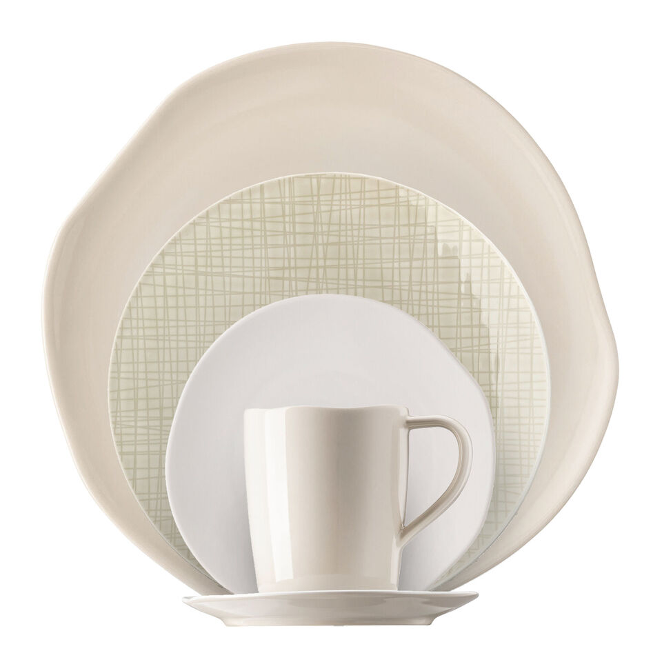 Various cream-colored dishes stacked in front of each other