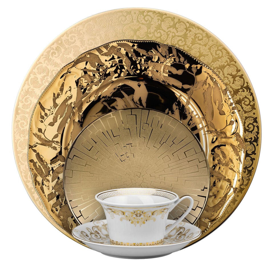 Various golden dishes stacked in front of each other