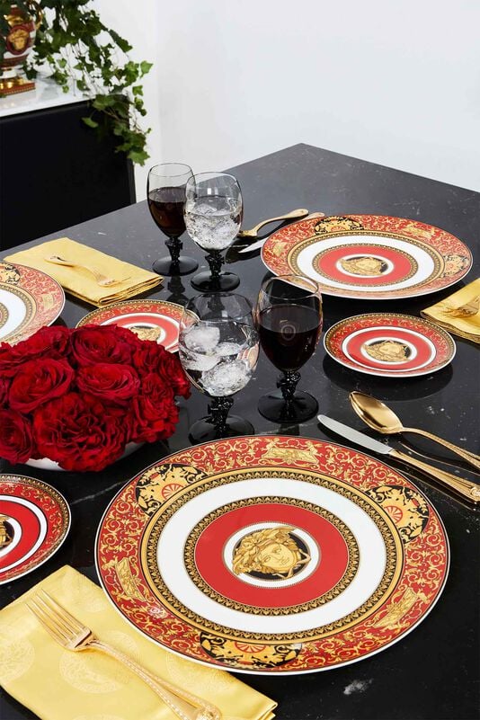 Rosenthal meets Versace Medusa Red Rosenthal meets Versace Medusa Red plates on black table with red roses