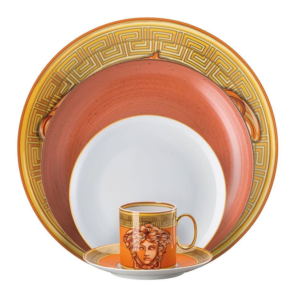 Various orange dishes stacked in front of each other