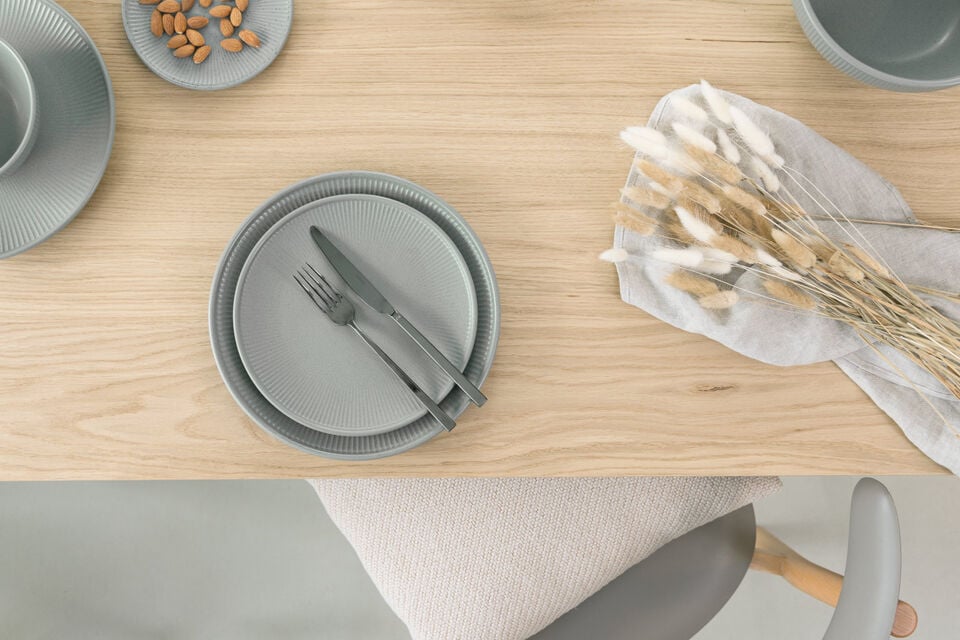 Gray Thomas Clay Smoke plates with cutlery on it on a wooden table