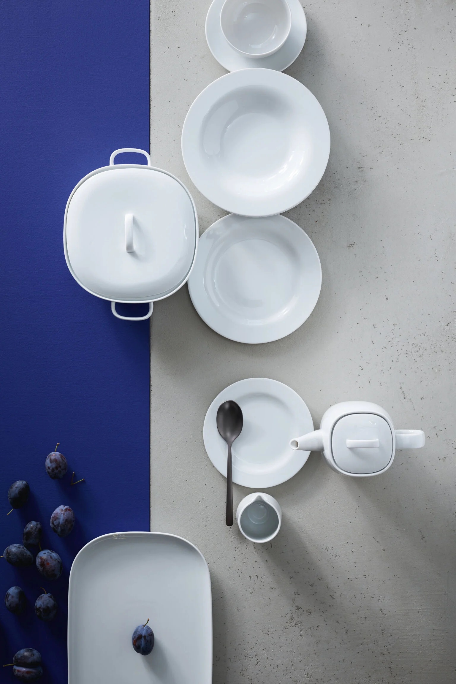 Rosenthal Moon White collection on a blue-grey striped background