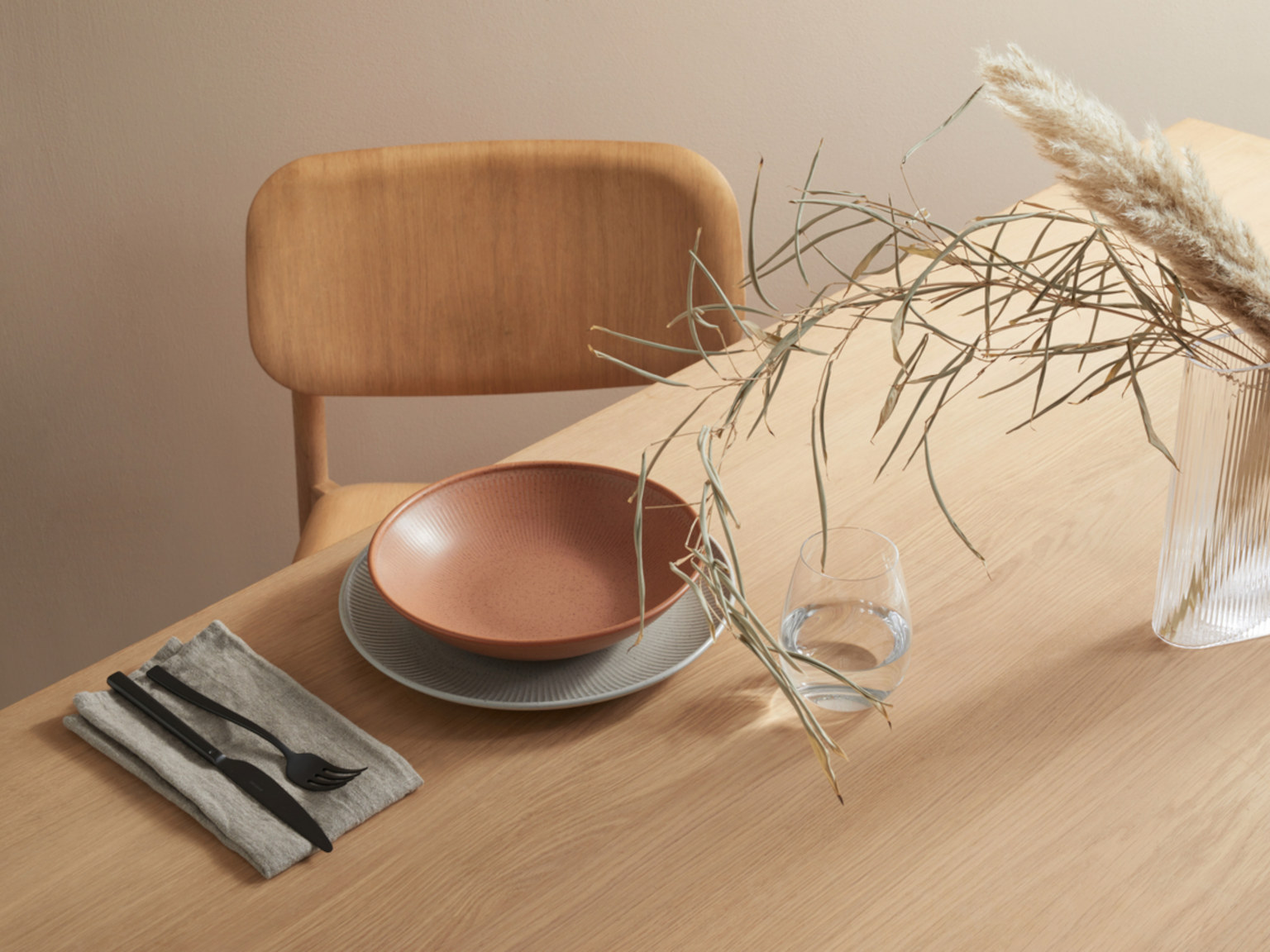 Table set with brown-colored Thomas Clay soup plate on a grey Thomas Clay dinner plate